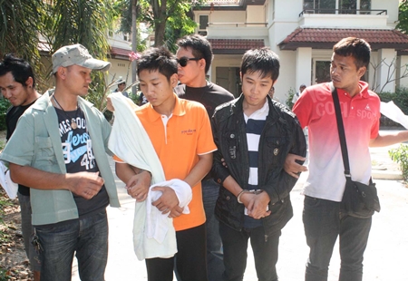 Abhisit Gayen and Bandit Khamwong are taken into custody at the Regent Village on Naklua Soi 16 after neighbors smelled meth cooking and called police.